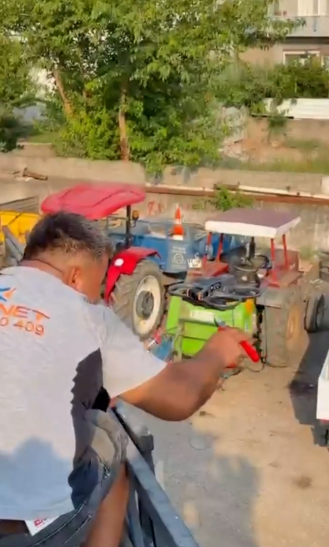 A worker uses pliers to cut the rope and take the drink from drone in Osmaniye, Turkey. A boss uses drones to deliver cold drinks to workers laying fibre internet cables on rooftops. Note: Photo is a screenshot from a video. (@AciFettah, Newsflash/NX)